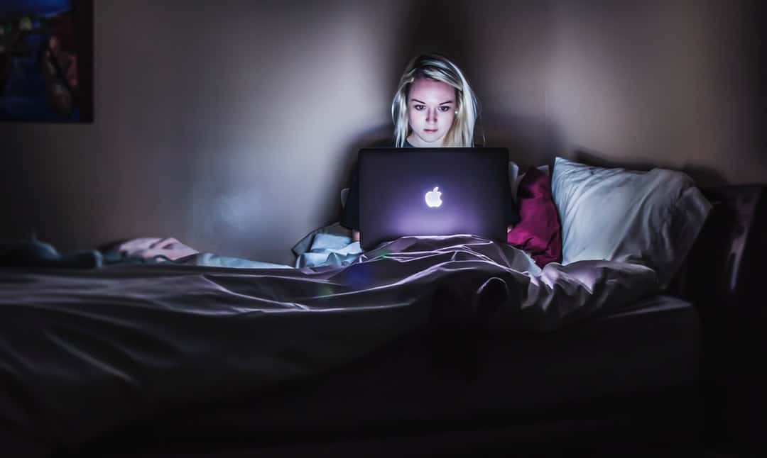 Woman researching mental health on laptop 